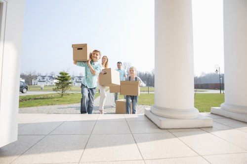 Movers handling furniture through narrow spaces in a flat