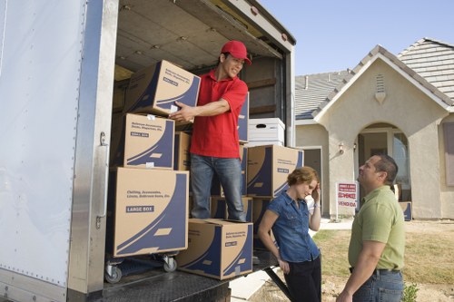 A piano being carried safely through a narrow staircase during relocation